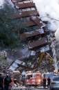 Firefighters pour water on the wreckage of 7 World Trade Center in New York City early September 12, 2001. 7 World Trade Center was destroyed along with both the landmark  World Trade Center towers after being struck by planes in a terrorist attack on September 11.                    REUTERS/Mike Segar