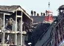 U.S. Federal Investigators search for clues near the damaged area of the Pentagon Building as fire fighters and rescue workers continue to battle smoke at the U.S. Military Headquarters outside of Washington, September 12, 2001. The Pentagon and the World Trade Center Buildings in New York City were attacked Tuesday after terrorists hijacked commercial jetliners and crashed them into the buildings.  REUTERS/Larry Downing