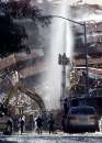 Fireman spray water on a collapsed section of the World Trade Center in New York on September 12, 2001. Planes crashed into each of the twin towers towers September 11 causing them to collapse.    REUTERS/Brad Rickerby