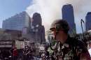 A National Guard soldier stands guard on West Street as the wreckage of the World Trade Center smolders in the backround in New York City September 12, 2001. The World Trade Center towers were destroyed after being struck by planes in a terrorist attack on September 11.  REUTERS/Mike Segar