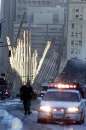 Police and other emergency workers surround a section of the World Trade Center building that had fallen into the middle of the street in New York on September 12, 2001. Two commercial planes crashed into each of the twin towers towers September 11 causing them to collapse.    REUTERS/Brad Rickerby