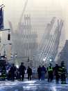 Workers walk near the wreckage of the World Trade Center in New York City  September 12, 2001. The World Trade Center towers were destroyed after being struck by planes in a terrorist attack on September 11.  REUTERS/Mike Segar