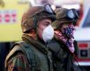 National Guard troops wearing protective face masks march down West Street near the wreckage of the World Trade Center in New York City  September 12, 2001. The World Trade Center towers were destroyed after being struck by planes in a terrorist attack on September 11.                                         REUTERS/Mike Segar