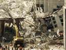 A piece of heavy construction equipment props up an endangered overpass as a section of one World Trade Center tower lies crumpled on the ground beside it (R)  while rescuers and emergency workers comb the smoking wreckage September 12, 2001 searching for trapped survivors of the terrorist attack on the New York landmark. Two hijacked commercial airliners were deliberately crashed into the twin towers bringing them crashing to the ground September 11.   REUTERS/Jim Bourg