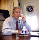 President George W. Bush talks on the phone with New York Mayor Rudy Giuliani and New York Governor George Pataki aboard Air Force One regarding the two planes that crashed into the World Trade Center in New York City, September 11, 2001. Bush began a series of meetings at the White House on September 12 aimed at finding out who was responsible and deciding on a just punishment. (Doug Mills/Pool via Reuters)