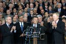 Leaders of the U.S. Congress applaud Senate Majority Leader Tom Daschle (C, at podium) during a ceremony at the U.S. Capitol September 11, 2001.  Joining Daschle from left to right are Senate Assistant Minority Leader Harry Reid, Senate Minority Leader Trent Lott, Speaker of the House Rep. Dennis Hastert, and House Minority Leader Richard Gephardt. Congress reconvened in a reopened and extra fortified U.S. Capitol, vowing to retaliate against the biggest terrorist attacks ever on American soil.  (Win McNamee/Reuters)