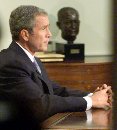 President George W. Bush pauses after addressing the nation from the Oval Office at the White House September 11, 2001. Bush said he would 'make no distinction' between terrorists and their hosts in the hunt for those responsible for killing thousands in attacks on the World Trade Center and Pentagon.  (Larry Downing/Reuters)