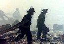 A group of firefighters walk amid rubble near the base of the destroyed World Trade Center in New York on September 11, 2001. Hundreds of firefighters and police are missing after two hijacked planes crashed into the Trade Center's twin towers a police source said. The source said there was an unconfirmed 265 firefighters and 85 police officers missing and feared dead. (Peter Morgan/Reuters)