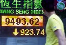 A passerby looks at a panel displaying the closing Hang Seng Index in Hong Kong September 12, 2001. The territory's key share index lost 8.87 percent or 923.74 points to close at 9,493.62, its biggest one-day percentage drop since the 1997-98 Asian financial crisis, in reaction to devastating attacks on landmarks in New York and Washington which shook investor confidence worldwide. (Bobby Yip/Reuters)