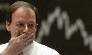 A trader at the Frankfurt stock exchange reacts after Europe's second largest financial center Frankfurt went back to work September 12, 2001. Financial markets were highly volatile in Europe, with stocks, bonds and the dollar yo-yoing violently as global central banks moved to inject liquidity into the straining financial system.  (Kai Pfaffenbach/Reuters)