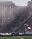 A lone American flag flies in front of the damaged area of the Pentagon building as firefighters and rescue workers continue to battle smoke at the U.S. military headquarters outside of Washington, September 12, 2001. The Pentagon reopened for curtailed business as rescue workers pressed the search for as many as 800 victims.  (Larry Downing/Reuters)