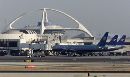 United Airlines jets sit at gates on the tarmac at Los Angeles International Airport, which has been closed for a second day September 12, 2001. The airport's theme building is in background. The planes which crashed into the World Trade Center and the Pentagon were bound for Los Angeles. (Fred Prouser/Reuters)