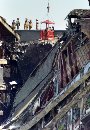 U.S. federal investigators search for clues near the damaged area of the Pentagon as firefighters and rescue workers continue to battle smoke at the U.S. military headquarters across the river from Washington, September 12, 2001. The Pentagon reopened for limited business as rescue teams pressed a perilous search for hundreds of missing defense workers.  (Larry Downing/Reuters)