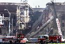 A fire truck sits in front of the damaged area of the Pentagon as firefighters and rescue workers continue to battle smoke at the U.S. military headquarters across the river from Washington, September 12, 2001. The Pentagon reopened for limited business as rescue teams pressed a perilous search for hundreds of missing defense workers.  (Larry Downing/Reuters)