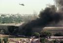 A helicopter flies over the burning Pentagon Tuesday, Sept. 11, 2001, in Arlington, Va. The Washington Monument can be seen at right, through the smoke. The White House roof is visible in the trees of Washington at left. (AP Photo/Tom Horan)